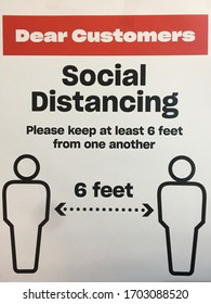 A Sign In A Public Space Asking Customers To Stay Six Feet Apart From Each Other 