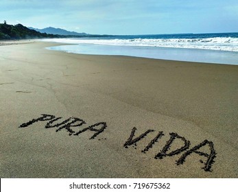 Sign Pura Vida Written In Black Sand Of Playa Negra Beach In Puerto Viejo, Costa Rica, Pura Vida (simple Life) Is Popular Symbol And Motto Of Costa Rica