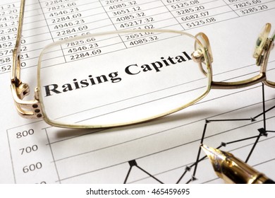Sign Raising Capital On A Paper And Glasses.