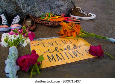 A sign reading "every child matters" is on display among some children's shoes and flowers at the Taber Hill Ossuary in Scarborough (Toronto), Ontario.