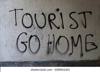 Sign Reading: Tourist Go Home