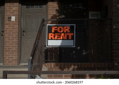 Sign For Rent At The Front Of A Residential House. Investment Property, Affordable Housing, Real Estate Crisis Concept.