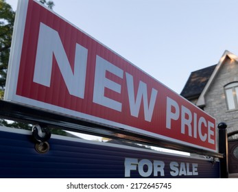 Sign For Sale New Price By Detached House In Residential Area. Real Estate Market Volatility,  Bubble, Crash, Hot And Cooling Housing Market, Overpriced Property, Buyer Activity Concept.  