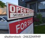 Sign for sale open house in front of detached house in residential area. Real estate bubble, crash, hot housing market, overpriced property, buyer activity concept.