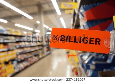 Sign saying “cheaper” in a German supermarket