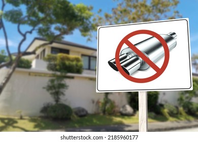 A sign saying no to open mufflers or loud exhausts near a house. Anti-noise pollution rules and regulations in a gated subdivision.
