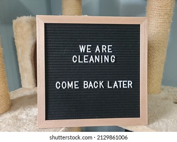 A Sign Saying We Are Cleaning Come Back Later. The Felt Sign Has Removable Letters Than Can Be Moved Around To Make Whatever Words Or Saying One Wants. 