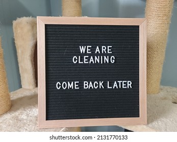 A Sign Saying We Are Cleaning Come Back Later. The Felt Sign Has Removable Letters Than Can Be Moved Around To Make Whatever Words Or Saying One Wants. 