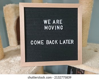 A Sign Saying We Are Moving Come Back Later. The Felt Sign Has Removable Letters Than Can Be Moved Around To Make Whatever Words Or Saying One Wants.