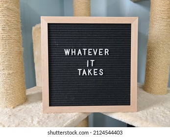 A sign saying whatever it takes. The felt sign has removable letters than can be moved around to make whatever words or saying one wants. 