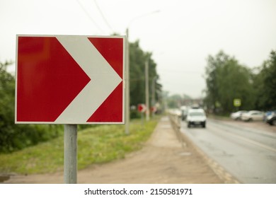 Sign Sharp Turn. Red Road Sign. Arrow Pointer On Road. Infrastructure For Transport.