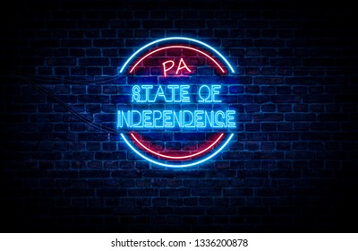 A sign showing Pennsylvania state slogan, in blue and red neon light on a brick wall background and wires on the side. - Shutterstock ID 1336200878