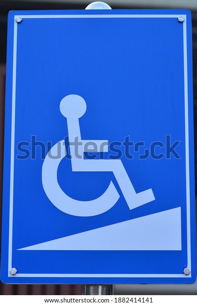 A sign\
showing the steep slope for the\
disabled