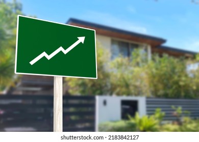 A sign showing an upward arrow in front of a gated house. Concept of increasing home prices and value or a real estate boom. - Shutterstock ID 2183842127