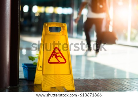 Sign showing warning of caution wet floor at airport