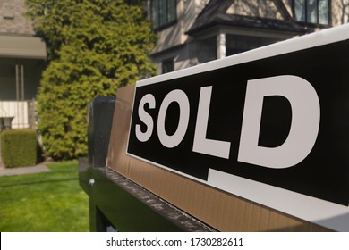 Sign Sold In Front Of A Detached House In Residential Area. Real Estate Bubble, New Listings, Hot Housing Market, Overpaid, Overpriced Property, Buyer Activity, Spring And Summer Sale  Concept.