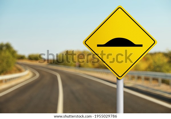 Sign Speed Bump\
near asphalt road outdoors.\
3d