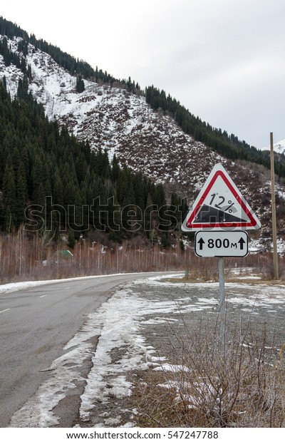 sign steep
descent in the mountains at the
turn
