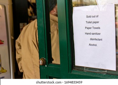 Sign at store stating they are sold out of toilet paper,paper towels,hand sanitizer,disinfectant and alchohol - Shutterstock ID 1694833459