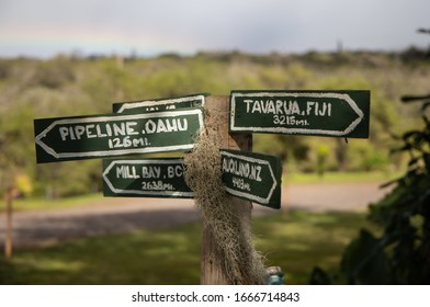 A Sign In A Sugarcane Field On The Island If Maui, Hawaii, Gives Directions And Distances To Fiji, New Zealand, Canada, And Oahu