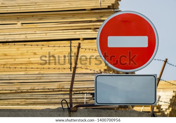 sign, symbol, warning about the\
prohibition of entry to the territory of the industrial zone with\
building materials, lumber, placed on the fence with barbed\
wire