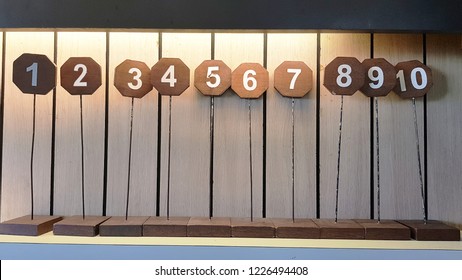 The Sign Of Table Numbers That Arrayed 
1 To 10 On Shelve In The Restaurant.