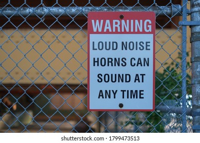 Sign Warning Loud Noise Horns Can Sound At Any Time On The Fence At Port.