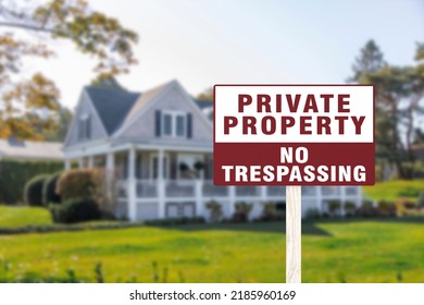 A sign warning private property and no trespassing in front of a luxury home. A cautionary signage.
