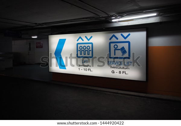 The sign of the way to elevator (lift) for\
passenger and service at the car park in the building. \
Bangkok,\
Thailand.\
5 July 2019.