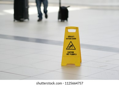 Sign of wet floor in the airport - Shutterstock ID 1125664757