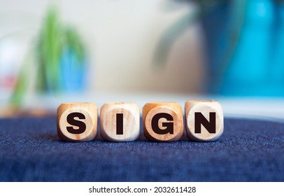 Sign Word Written In Wooden Cubes On An Isolated Light Table. Singing, Karaoke Or Vocal Training Concept.	