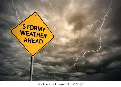 Sign with words 'Stormy weather ahead' on a background of thunderclouds with lightnings