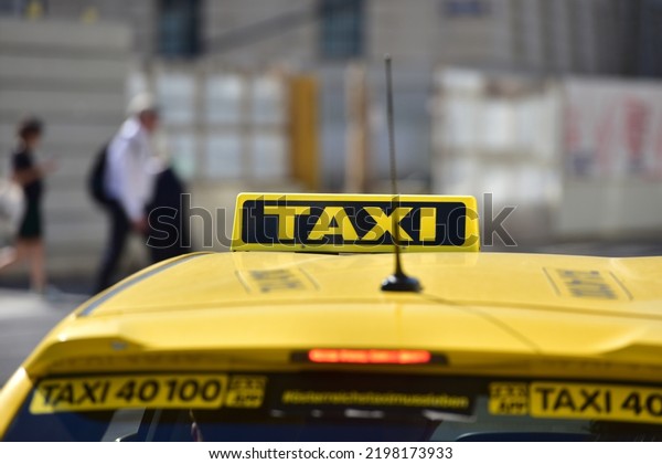 Sign of a yellow taxi\
in Vienna, Austria