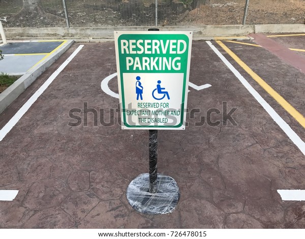 A signage showing priority or\
dedicated parking lot for pregnant woman and disabled\
person