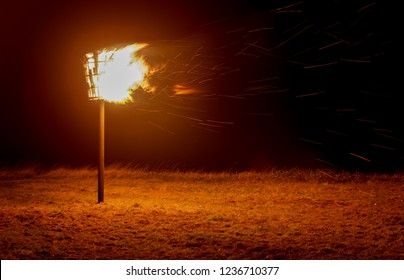 A Signal Beacon On Fire With Smoke And Sparks. 