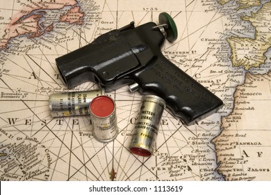 Signal Flare Gun And 3 Rounds On Top Of Old Marine Map