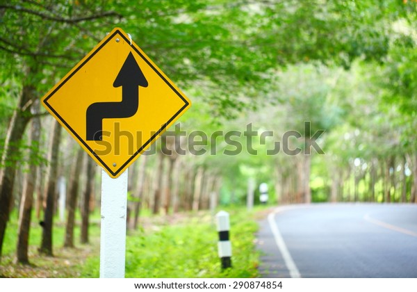 Signal right reverse Turn right on the road\
in a rubber plantation.