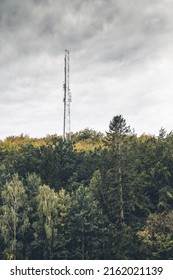 A Signal Tower Behind The Treeline.