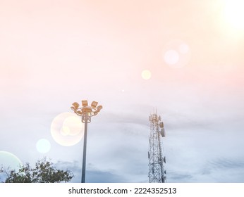 The Signal Tower And The Spotlight Were Taken In The Same Shot In The Sky With Sunlight And There Is A Fair Light Being Created.