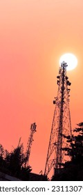 signal transmitting tower behind the evening sun - Shutterstock ID 2311307975