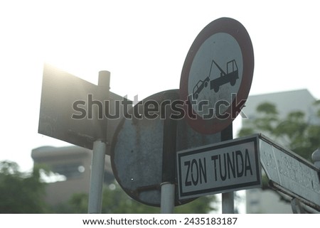 Signboard warning for tow area with whitebackground.
