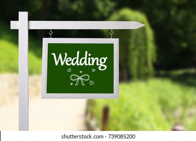 Signboard with word WEDDING outdoors