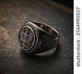 A signet ring is a type of ring traditionally engraved with a unique symbol, such as a family crest, initials, or monogram, often used to represent a family, organization, or individual. 