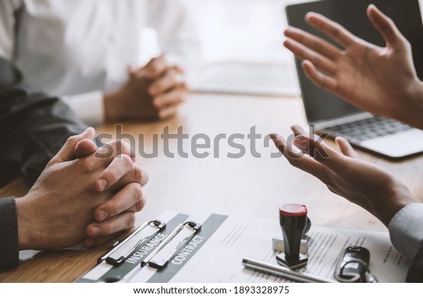 Signing a business contract. A group of\
business people meeting and signing an investment, buying and\
selling home and real estate\
agreement.