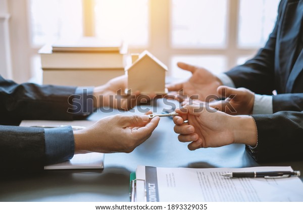 Signing a business contract. A group of
business people meeting and signing an investment, buying and
selling home and real estate
agreement.