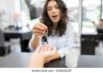 Signing Of Home Purchase Contract, Home Sale Woman Picking Up Keys To Her New Home, Approach In Hand With Keys - Key Handover Concept - Focus In Keys