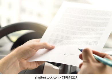 Signing Lease Or Buying New Or Used Car. Man About To Write Autograph To Legal Document. Motor Vehicle Insurance Agreement. Rental Contract Paper.