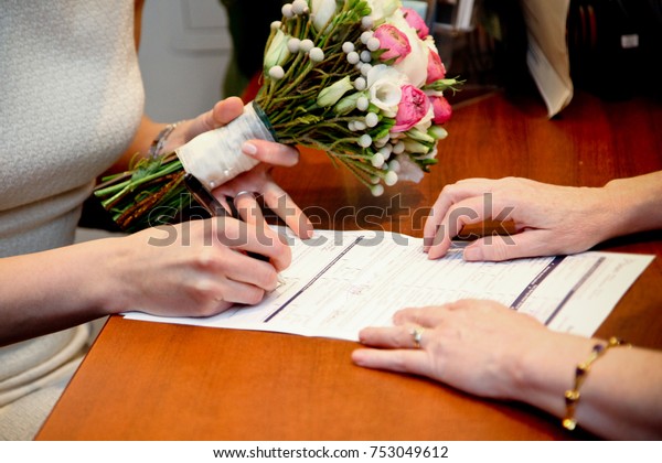 Signing the marriage\
certificate