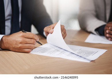 Signing Off Another Big Business Deal. Closeup Shot Of Two Unrecognizable Businesspeople Going Through Paperwork In An Office.