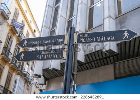 Signpost in the City Centre with directions to tourist attractions.In the evening hours.Malaga, Spain, Andalusia.